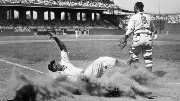 ELECTRIC SLIDE
Josh Gibson (crossing the plate during a Negro leagues All-Star Game in 1944) may well be the best power-hitting catcher—any league, any era. He was known as the Black Babe Ruth, though some who saw him play refer to the Bambino as the white Josh Gibson.

